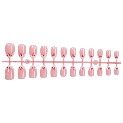 Stylish French manicure with a bow design.