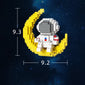 Astronauts assemble building block toys.