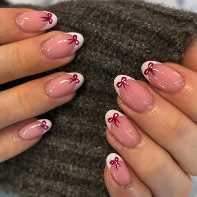 Stylish French manicure with a bow design.